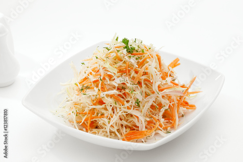 close up view of fresh vegetable salad on white background
