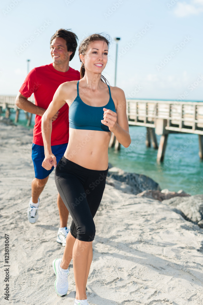 Young Woman and Man Joggers in South Beach