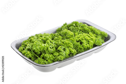 Parsley in plastic packaging for sale, isolated on white background
