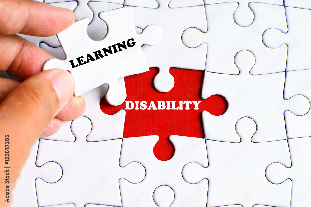 "DISABILITY" word on missing puzzle with a hand hold a piece of