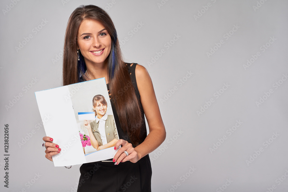 Smiling business woman showing advertising brochure Smiling business woman showing advertising brochure