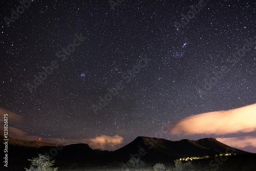 The starry sky captured Karoo National Park, South Africa, in winter. The Pleiades star cluster, Orion and Taurus Constellation clearly visible.