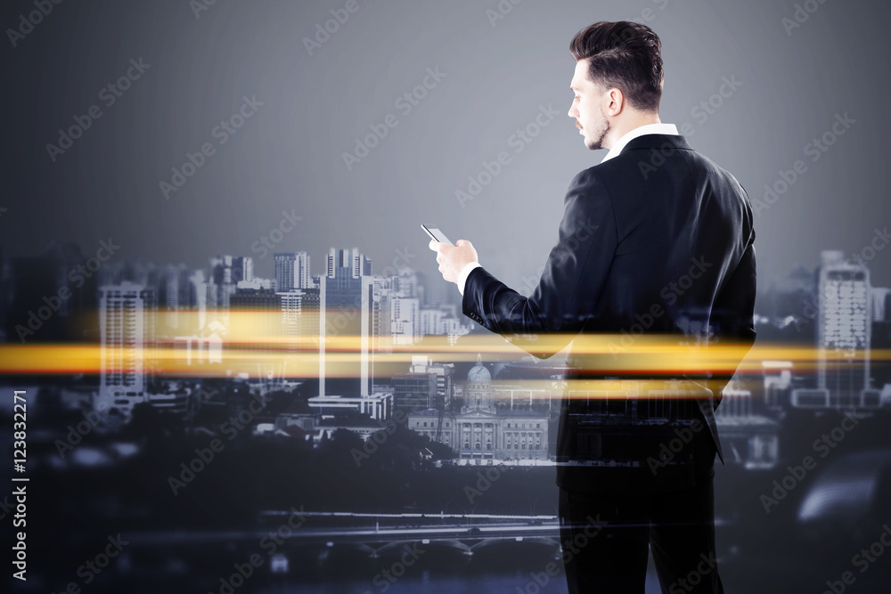 Fototapeta premium Businessman with smartphone and orange city