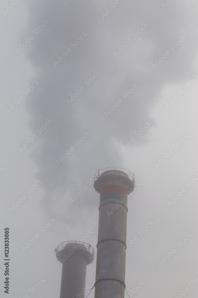 Air pollution from coal-powered plant smoke stacks, and industrial cityscape, on a gloomy, overcast day Air pollution from coal-powered plant smoke stacks, and industrial cityscape, on a gloomy, overcast day