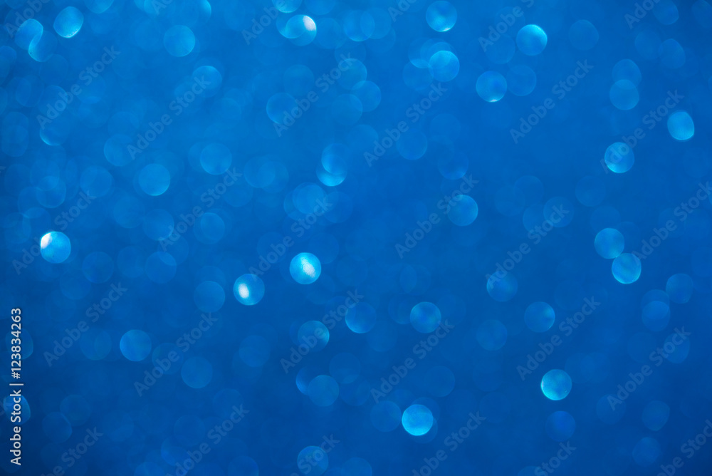 Unfocused abstract blue glitter bokeh holiday background. Winter xmas holidays. Christmas.