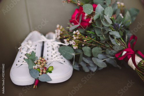 Fototapeta Naklejka Na Ścianę i Meble -  wedding set of bridal bouquet and white sport shoes and groom boutonniere