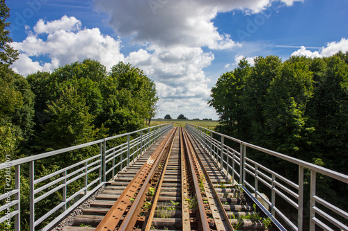 Old railway in the summer forest.