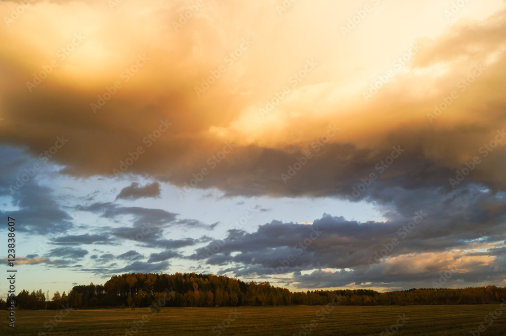Dark stormy clouds over field