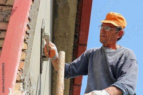 Builder Worker At Plastering Facade Work