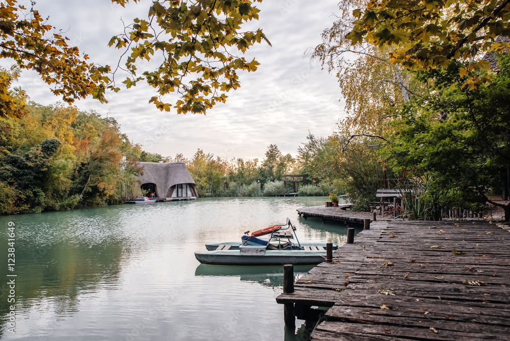 Lake and smart wood in sunny day. Wooded shores. Indian summer. The boat near the coast. Wooden house. Beautiful nature. Outdoor recreation Lake and smart wood in sunny day. Wooded shores. Indian summer. The boat near the coast. Wooden house. Beautiful nature. Outdoor recreation