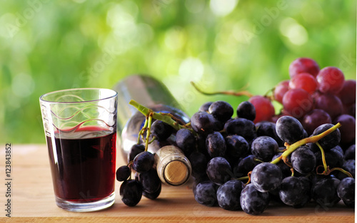 grapes and red wine on table