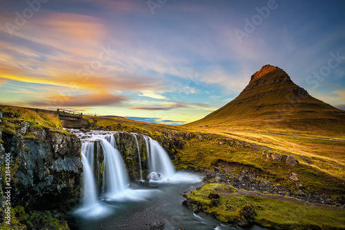 Sunset over Kirkjufellsfoss Waterfall and Kirkjufell mountain in Iceland