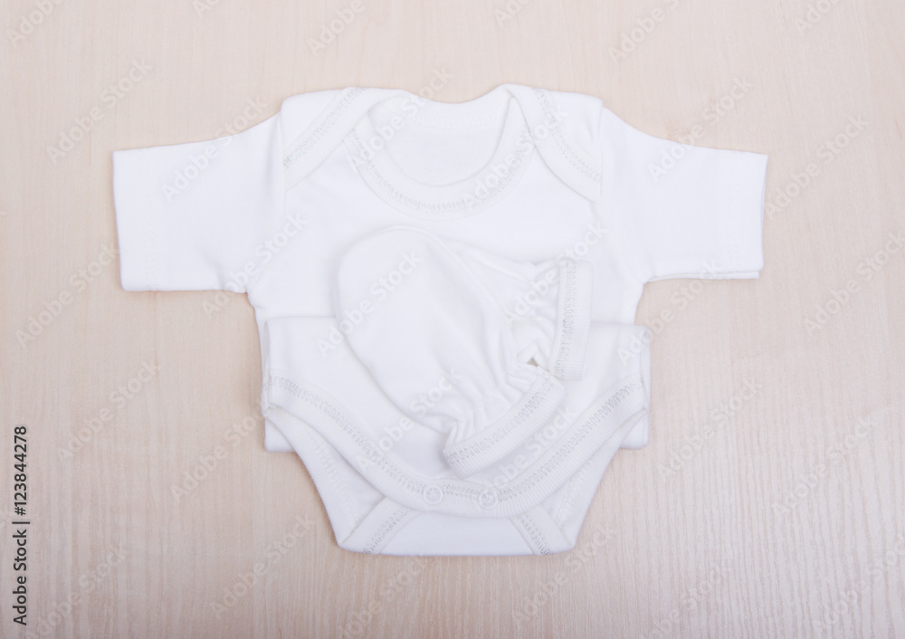 Baby goods. Baby blouse and pants sliders pijama. Children's clothing  diapers pajamas mittens socks vests sliders white Stock Photo | Adobe Stock