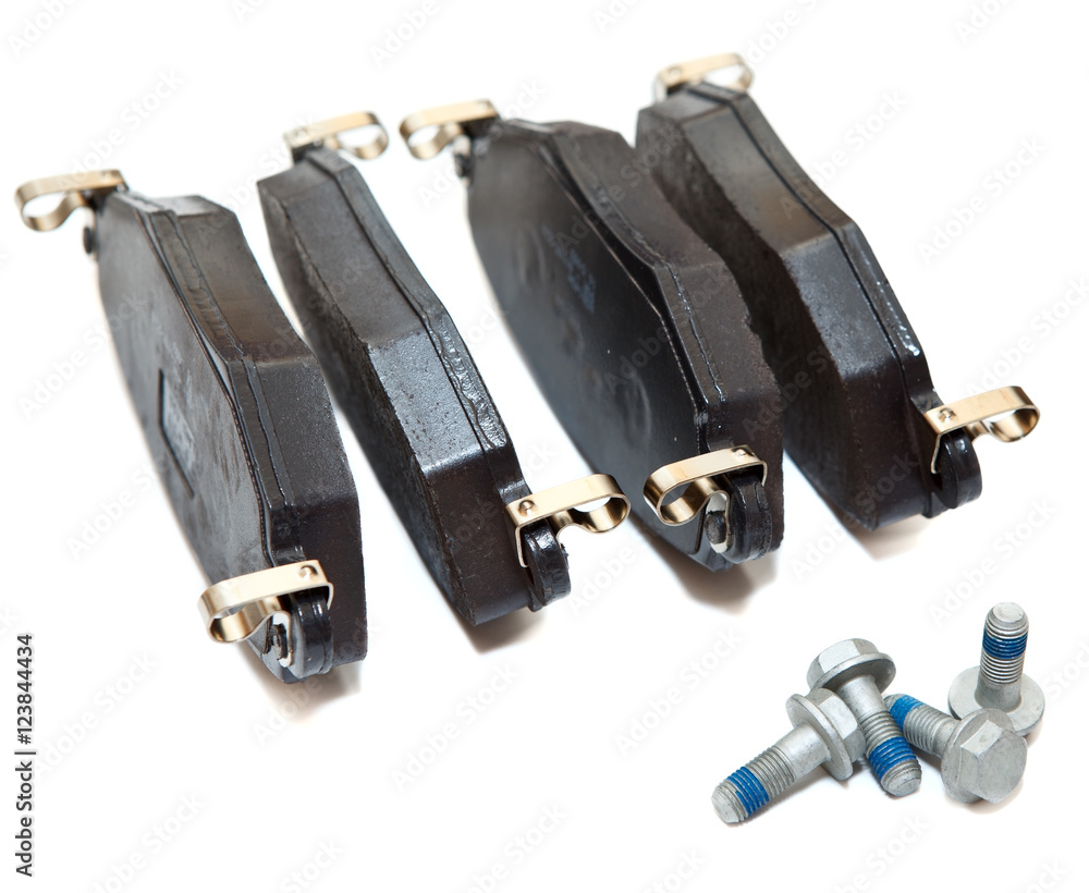 New brake pads with screws isolated on white background New brake pads with screws isolated on white background