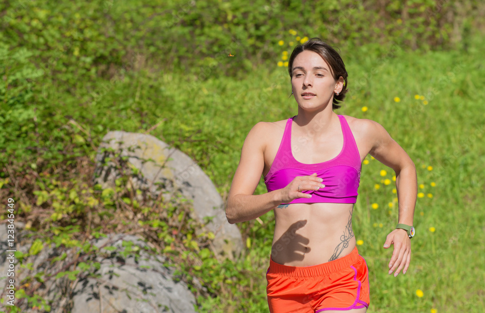 Beautiful athletic woman running in countryside Beautiful athletic woman running in countryside