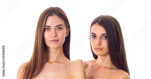 Two young woman with long hair in studio