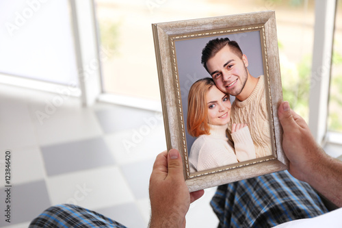 Male hands holding photo fr...
