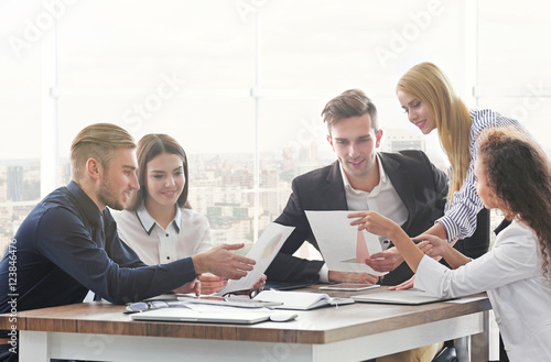 Young business people discussing a new project at the meeting in office