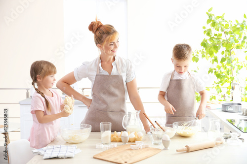 Young mother and kids makin...