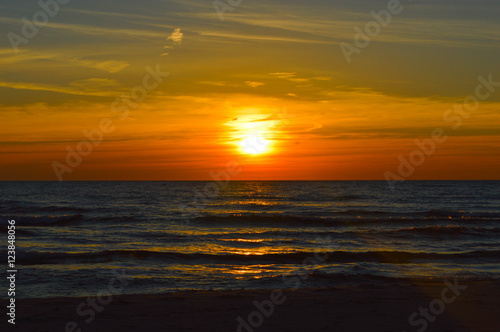 Fototapeta Naklejka Na Ścianę i Meble -  Brilliant sunrise over the waters of lake Huron in Oscoda, Michigan