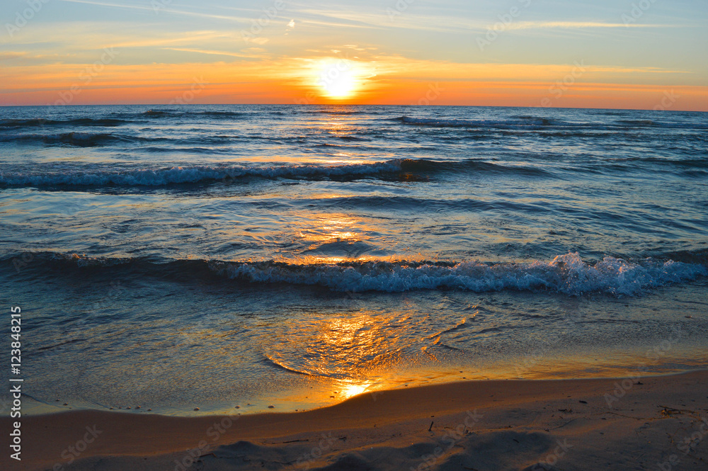 Brilliant sunrise over the waters of lake Huron in Oscoda, Michigan