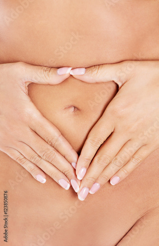 Hands on slim female belly