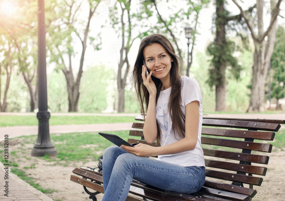 Beautiful girl with a phone and a e-book Beautiful girl with a phone and a e-book