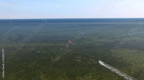Man Riding a Kite on the Sea