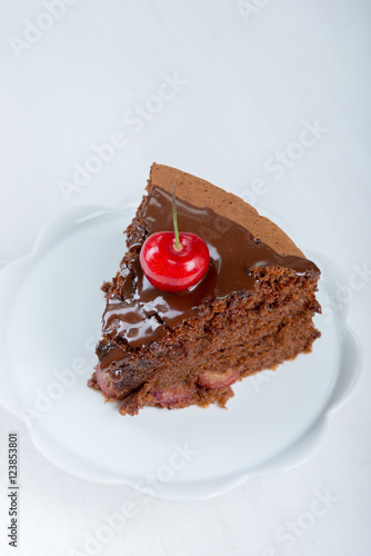 Chocolate cake with juicy cherries photo