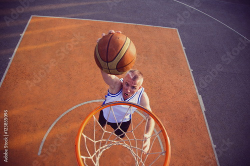 Basketball street player making a slam dunk © FS-Stock