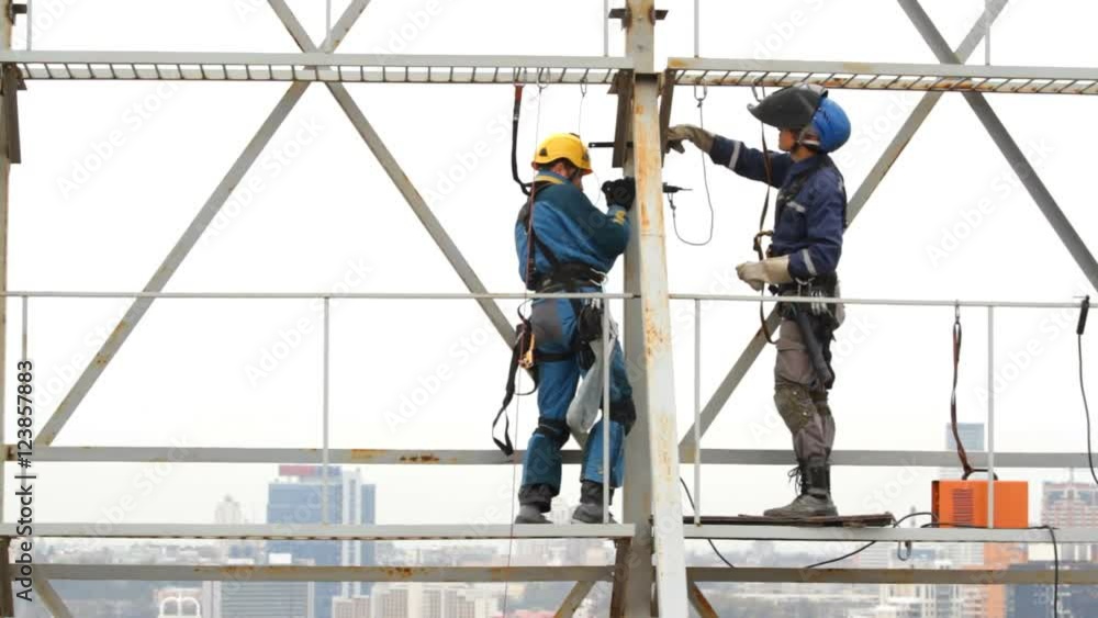 Industrial Climber Works at a Height of Weld Design. Industrial Climber Works at a Height of Weld Design.