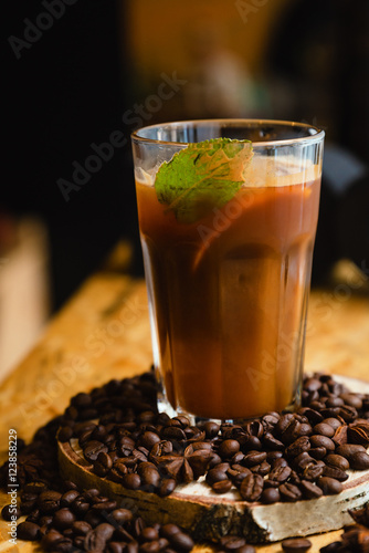 Cold coffee with ice and mint in a cafe