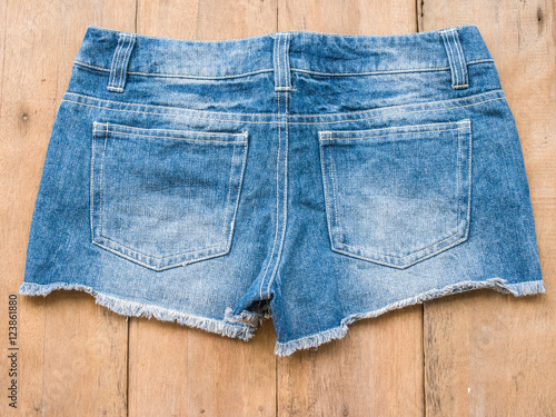 Short jean with belt on wood background
