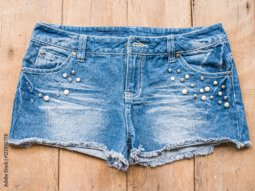 Short jean on wood background
