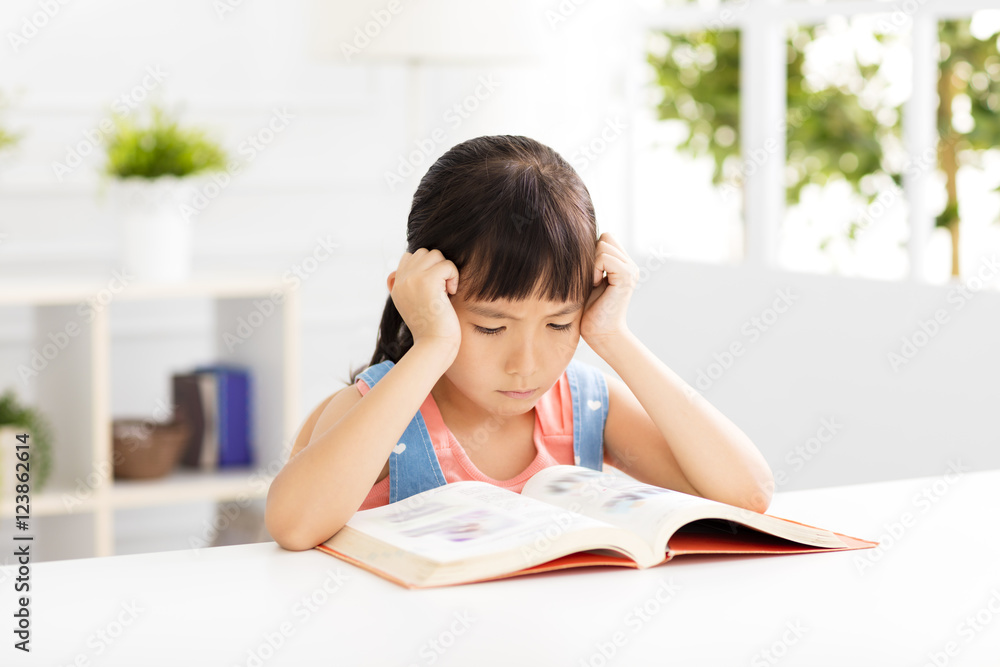 Stressed little girl study in living room Stressed little girl study in living room