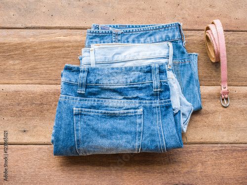 Short jean with pink belt on wood background

