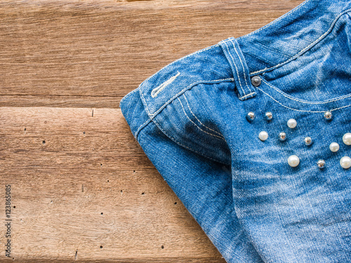 Short jean with belt on wood background
