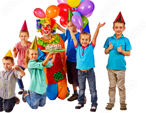 Clown keeps bunch of balloons and birthday cake with group children. Happiness and joy childhood. Isolated.