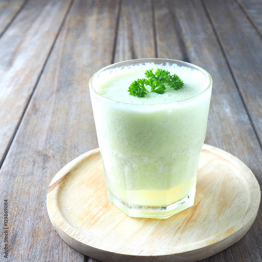 Close up of a glass of melon with yogurt smoothie on a wooden table. Close up of a glass of melon with yogurt smoothie on a wooden table.
