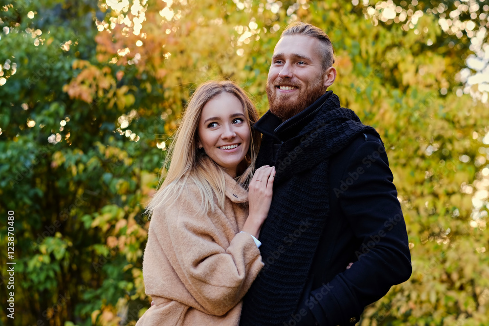 Fototapeta premium Bearded male hugs the cute blonde female on the date.