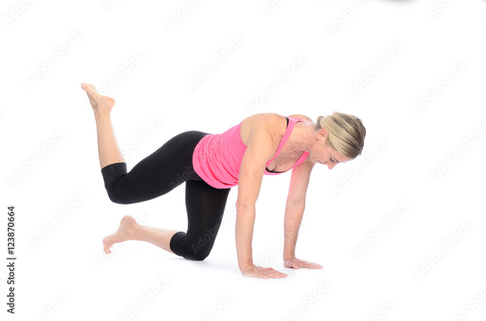 Fit woman strengthening her thigh muscles Fit woman strengthening her thigh muscles