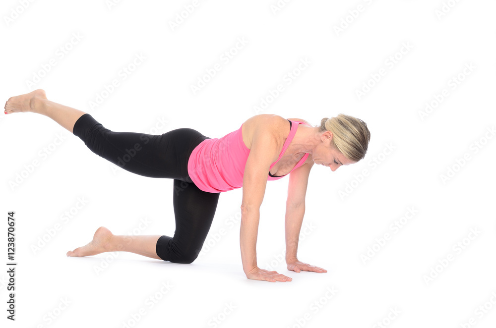 Fit woman strengthening her thigh muscles Fit woman strengthening her thigh muscles