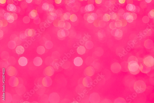 Bokeh glamour pink background with blurred rainbow lights. Festive background.