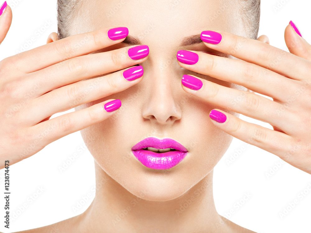 Close-up face of a beautiful  girl with  purple nails and lips.
