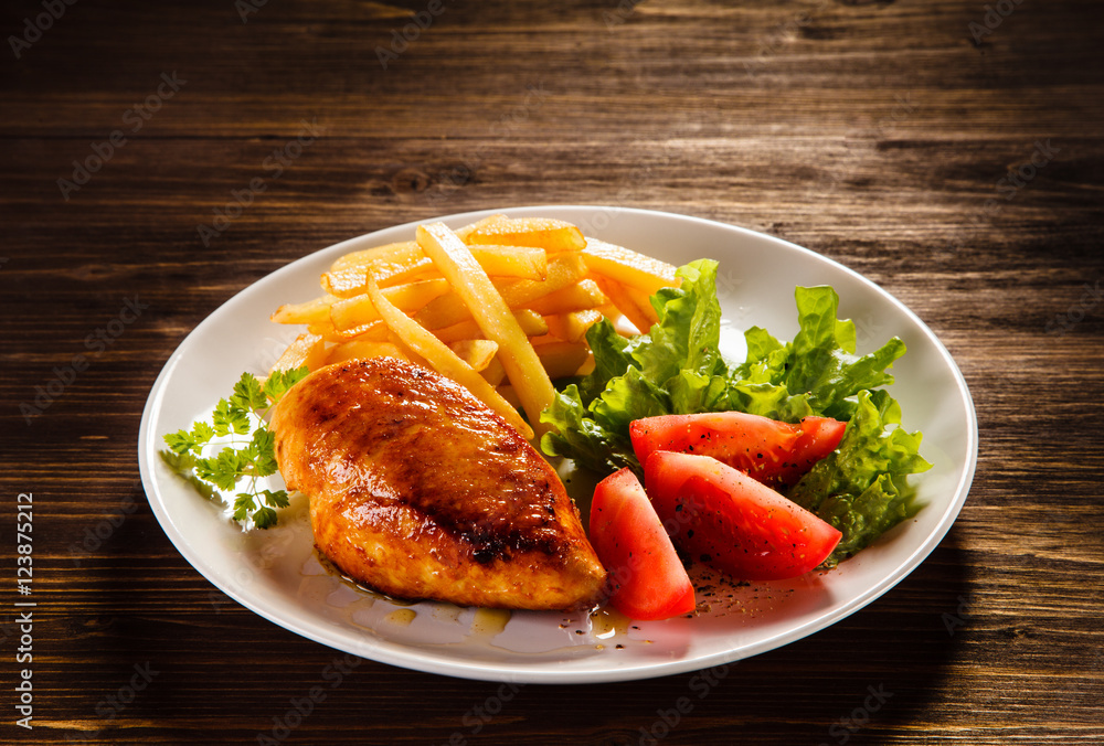 Fried chicken fillet, chips and vegetable salad Fried chicken fillet, chips and vegetable salad