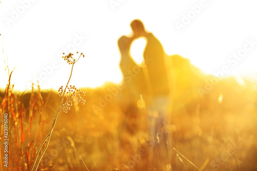 Closeup shot of young couple kissing outdoor. Close up of loving couple embracing and kissing