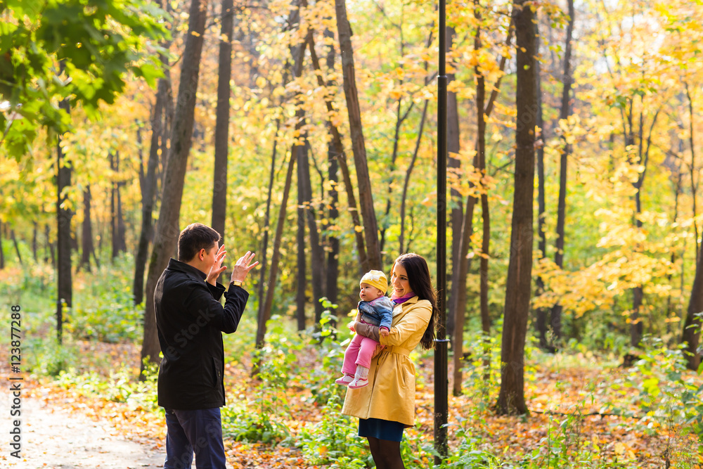 Fototapeta premium Happy family playing in autumn park