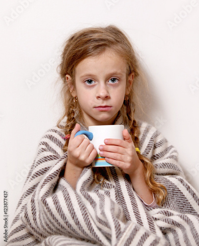 a little girl with a mug, temperature , illness, blanket