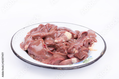 Raw chicken liver in the metal plate over white
