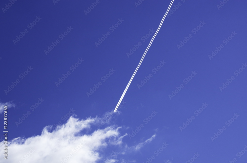 Trail from a jet aircraft in a blue sky. Trail from a jet aircraft in a blue sky.